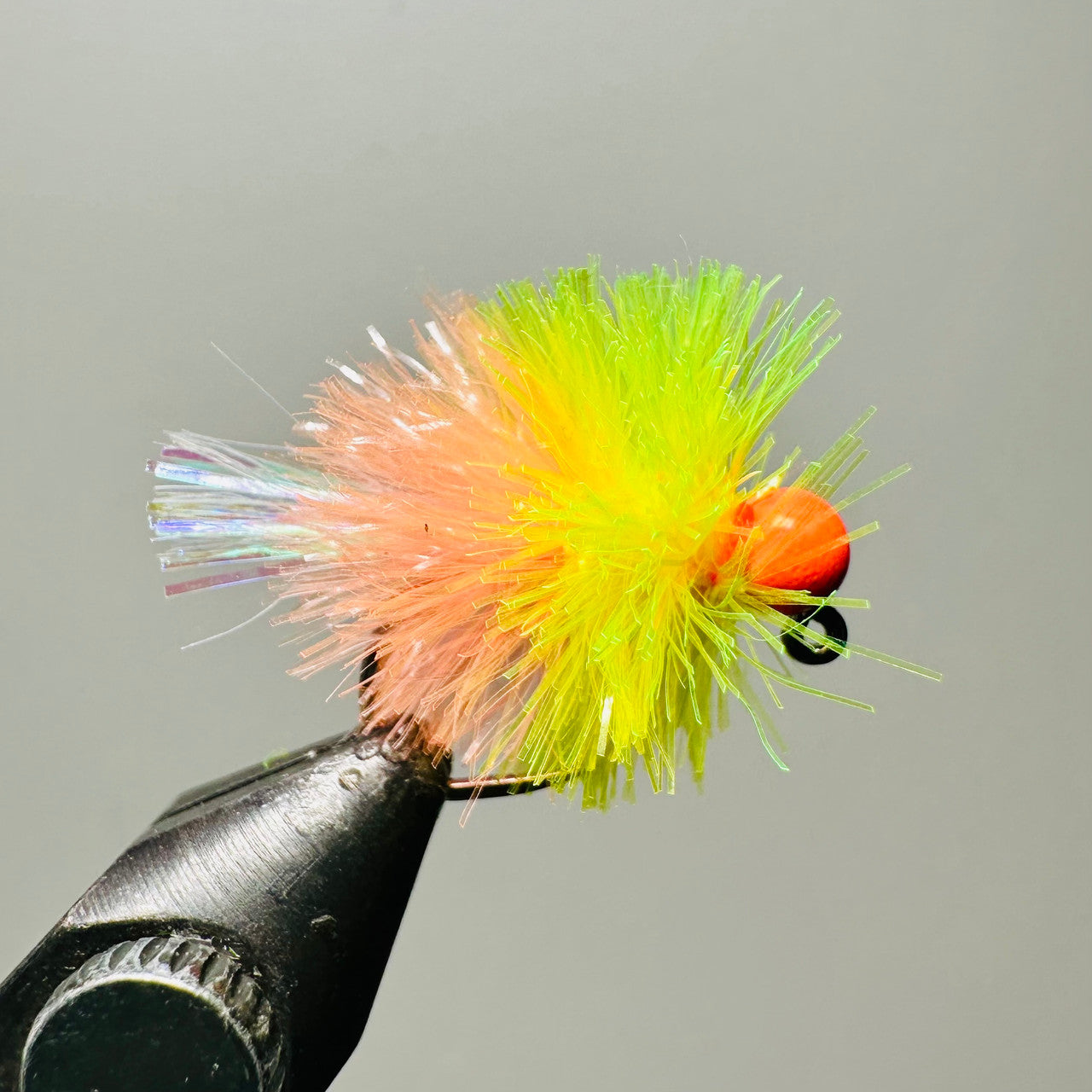 Blend of coral pink, vibrant atomic yellow with a fluorescent orange tungsten bead